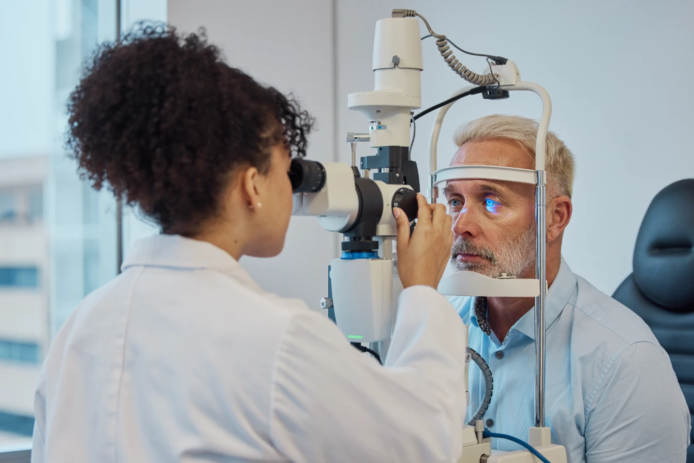dry eye therapy ophthalmology examination Optometrist examining patient's eyes with slit lamp microscope